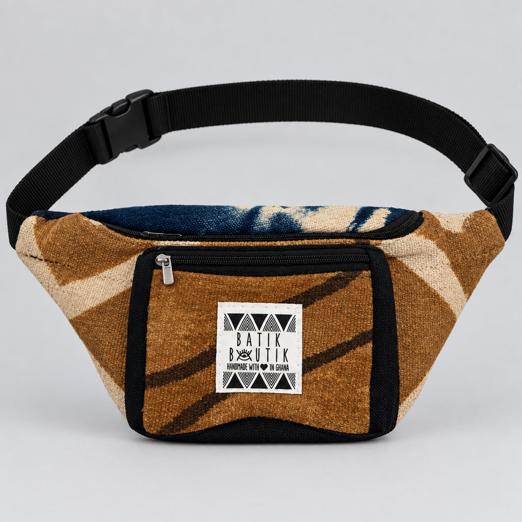A small batik fabric fanny pack with a brown and beige pattern, black trim, and a white brand label reading 'BATIK BUTIK'.