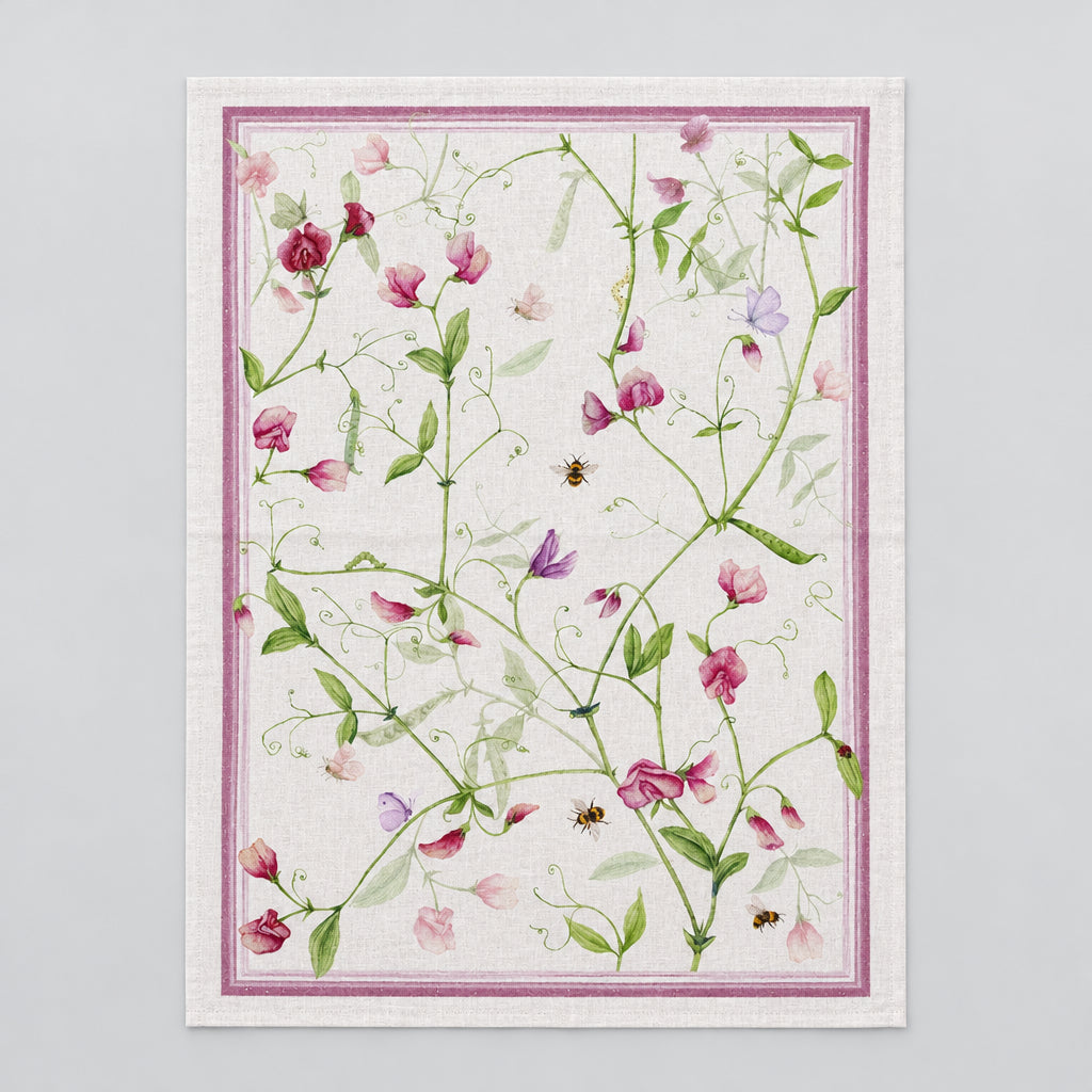 Floral patterned fabric with pink flowers and green leaves on a white background