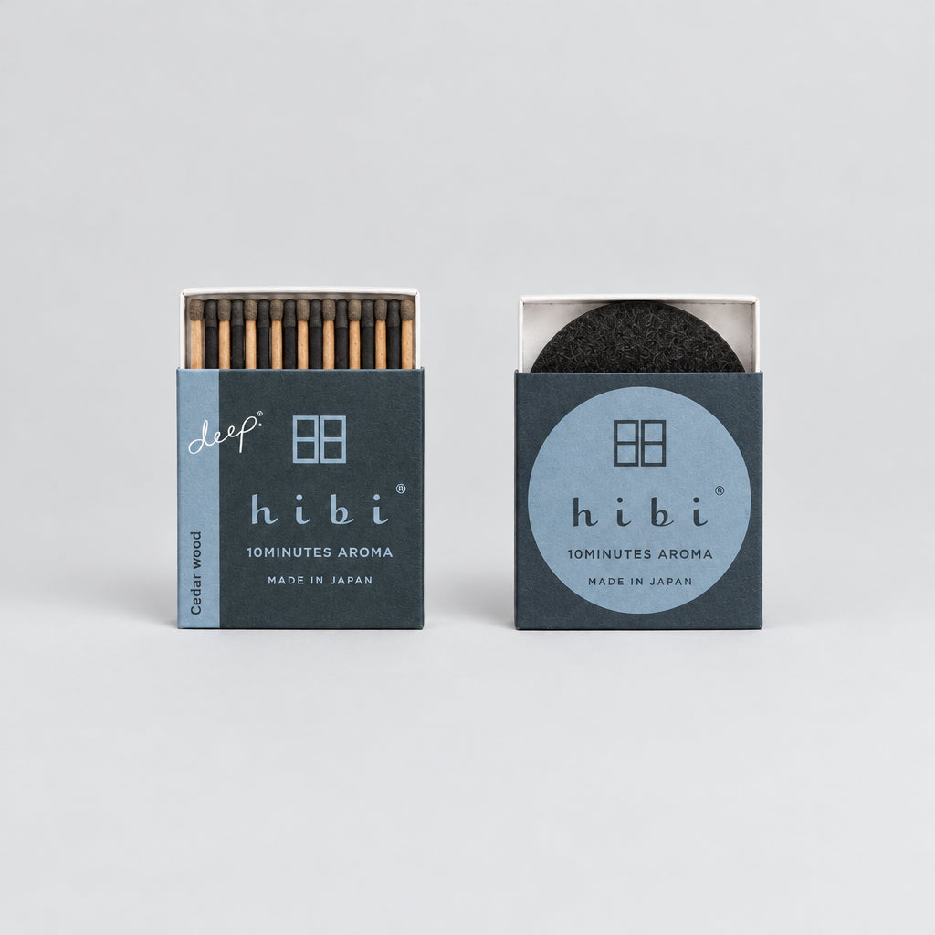 Two matches in their retail packaging on a plain white background. The left package is labeled 'deep hibi 10MINUTES AROMA' and shows wood-toned matches inside.
